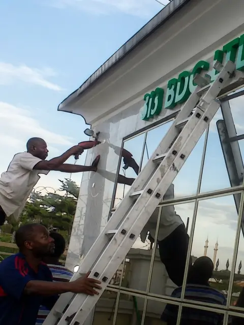 Team installing 3D letters for 313 Bureau De Change in Wuse Zone 6 Abuja