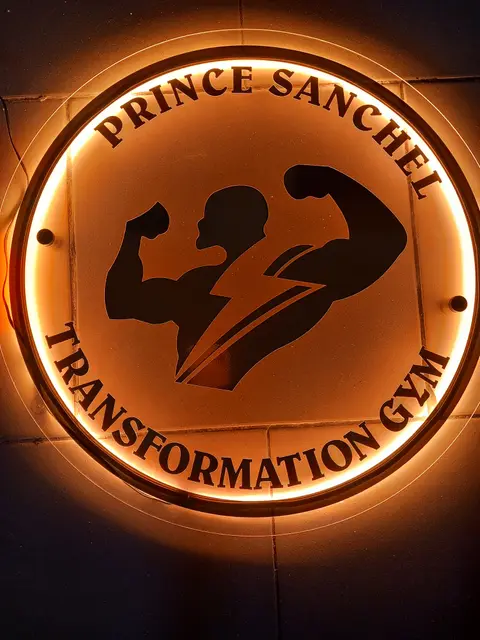 Circular backlit mirror-gold sign for Prince Sanchel Transformation Gym