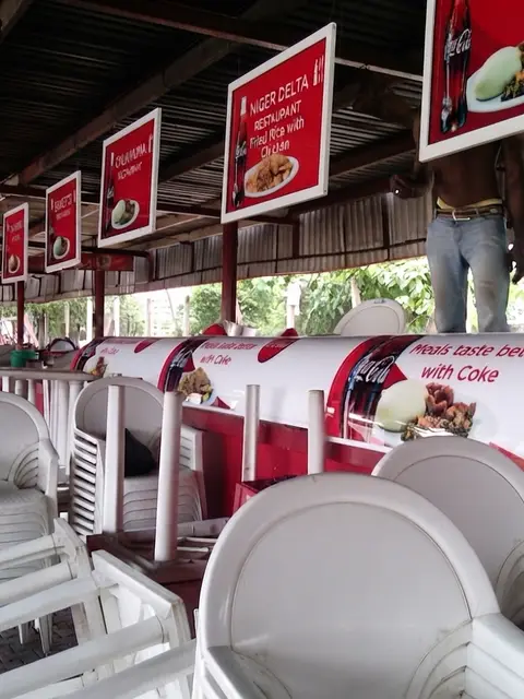 Coca-Cola counter wrap and hanging menu lightboxes at Eagle Square Food Court Abuja