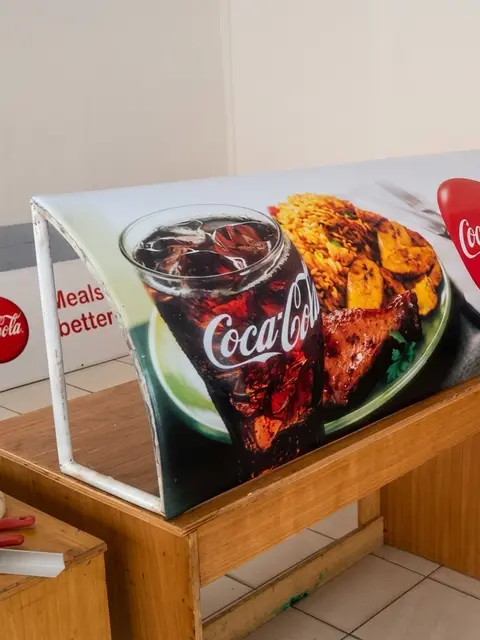 Curved Coca-Cola counter wrap section during fabrication