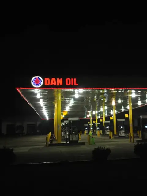 Dan Oil station canopy glowing at night with red LED trim