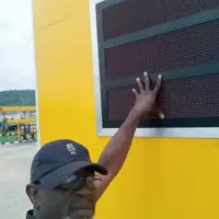 PRECISION founder checking an LED display board on a station pylon