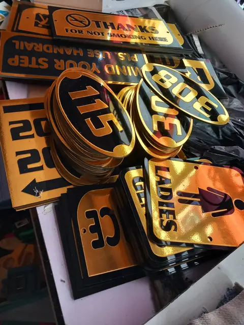 Precision-cut gold mirror plaques and room numbers for Saratoga Hotels