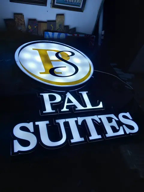 Halo-lit letters and logo lightbox for Pal Suites glowing in the workshop