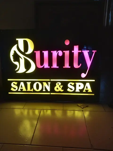 Purity Salon and Spa sign with multicolour LED faces lit up