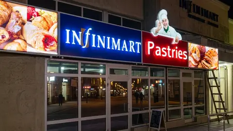 Infinimart Pastries lightbox signs glowing at night