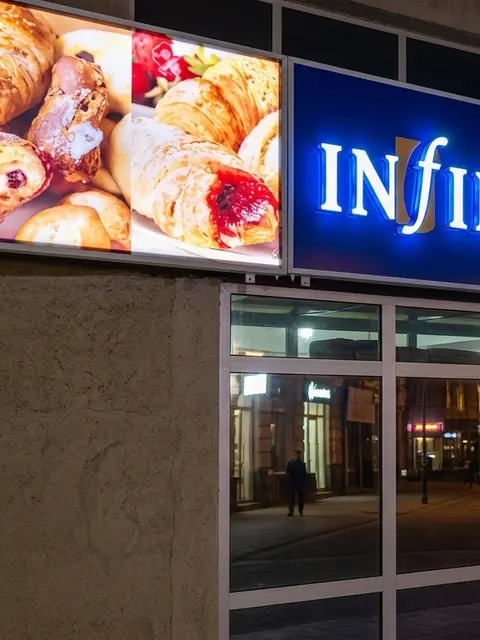 Infinimart Pastries lightbox signs glowing at night