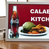 Illuminated Calabar Kitchen menu lightbox with Coca-Cola branding