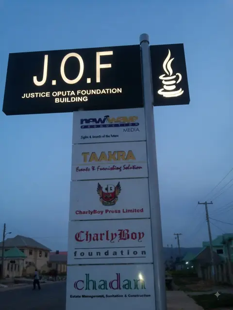 Multi-tenant pylon with illuminated header at the Justice Oputa Foundation Building